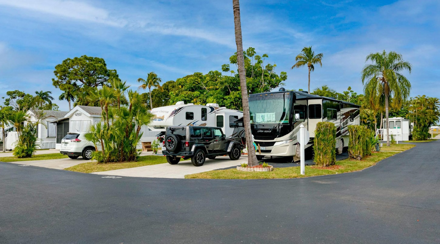 RVs and SUVs parked near manufactured homes