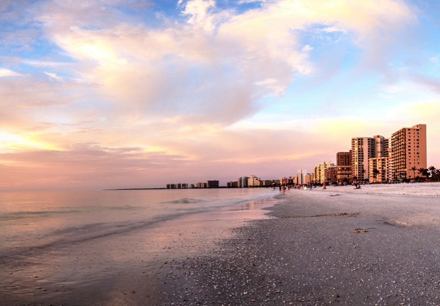 Marco Island, Florida beach area with medium-rise buildings in the back